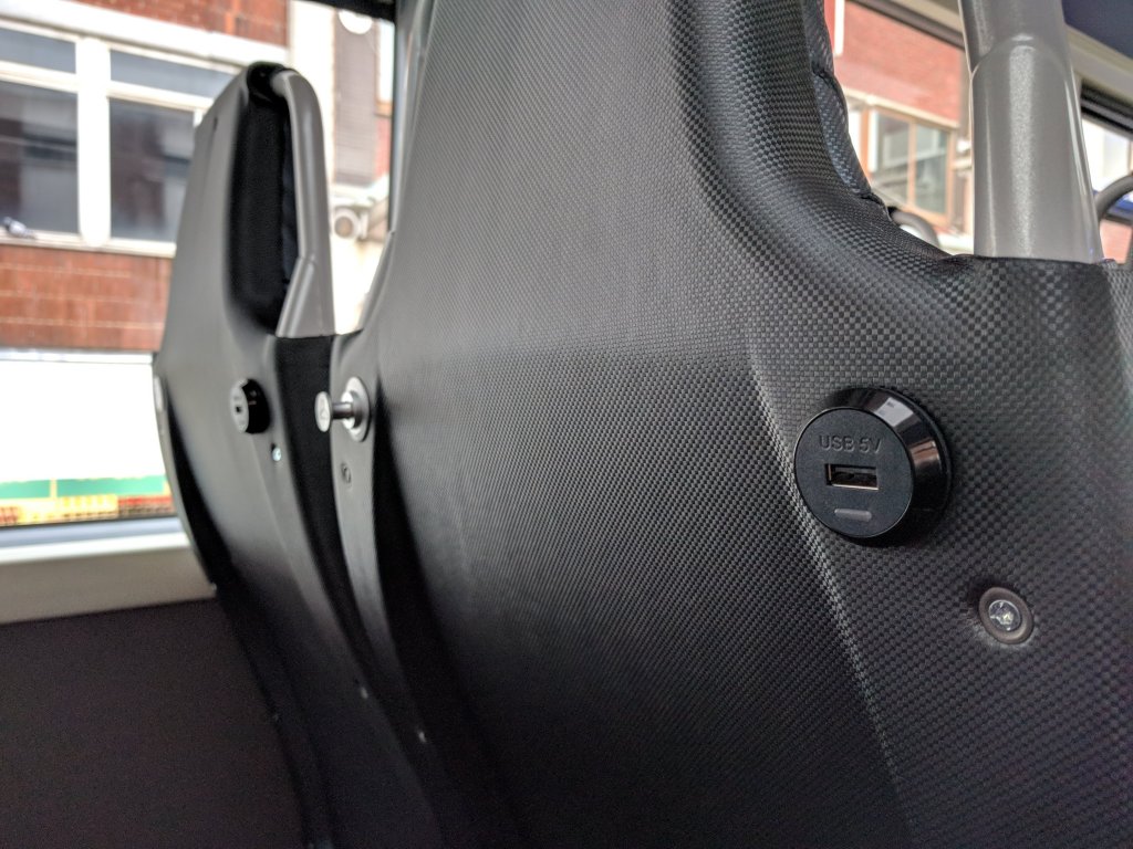 An interior photo showing the USB chargers and retractable coat hooks found on the seat backs